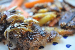 Hakkebøf med bløde, glaserede løg og pommes frites med sesam